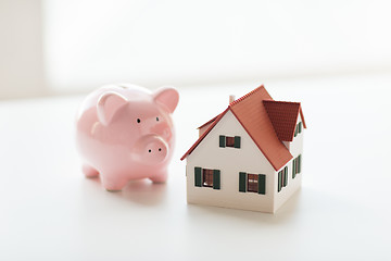 Image showing close up of house model and piggy bank