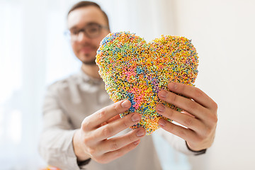 Image showing close up of happy man with heart at home