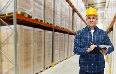 Image showing happy man in helmet with clipboard at warehouse