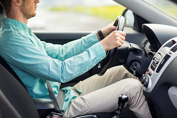 Image showing close up of young man driving car