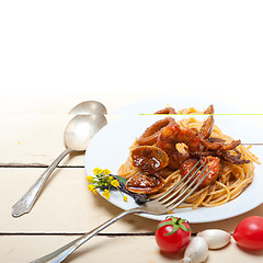 Image showing Italian seafood spaghetti pasta on red tomato sauce 