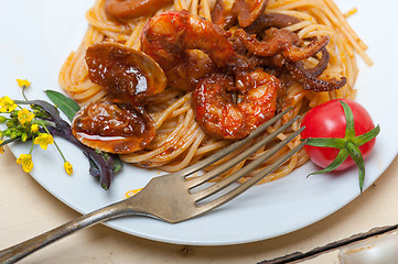 Image showing Italian seafood spaghetti pasta on red tomato sauce 