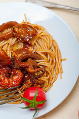 Image showing Italian seafood spaghetti pasta on red tomato sauce 