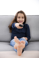 Image showing Girl holding a TV remote