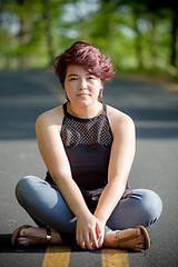 Image showing Young Woman Sitting in the Road