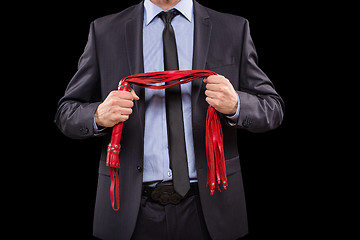 Image showing man in business suit with chained hands. handcuffs for sex games