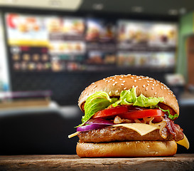 Image showing fresh tasty burger on wooden table