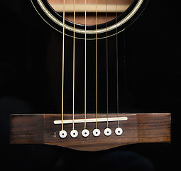 Image showing Detail of an acoustic black guitar