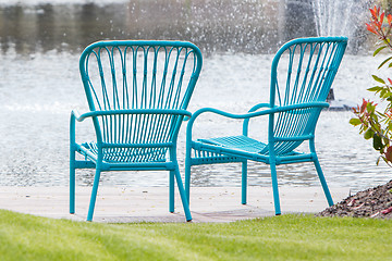 Image showing Two blue chairs at the waterfront