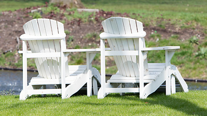 Image showing Two white chairs at the waterfront