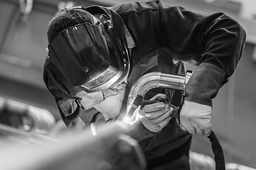 Image showing Industrial worker welding in metal factory.