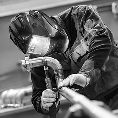 Image showing Industrial worker welding in metal factory.