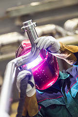 Image showing Industrial worker welding in metal factory.