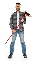 Image showing Young worker with a broom