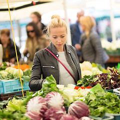 Image showing Woman buying vegetable at local food market. 