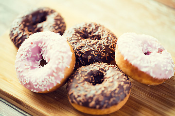 Image showing close up of glazed donuts pile on table