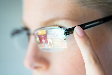 Image showing close up of woman in glasses with virtual screen