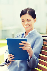 Image showing smiling business woman with tablet pc in city