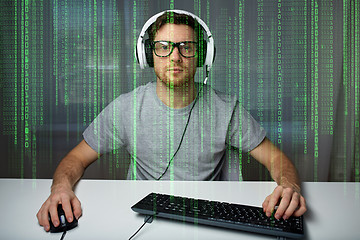 Image showing man in headset playing computer video game at home