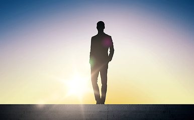 Image showing silhouette of businessman over sun light