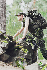 Image showing young soldier with backpack in forest