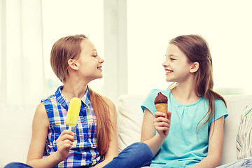 Image showing happy little girls eating ice-cream at home