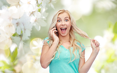 Image showing smiling young woman calling on smartphone