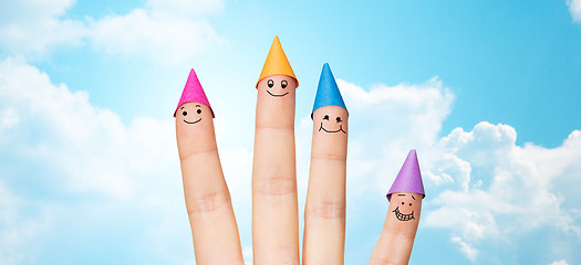 Image showing close up of hand with four fingers in party hats
