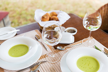 Image showing close up of soup and water glasses at restaurant