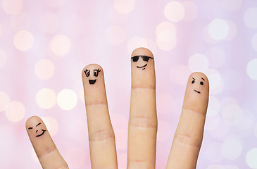 Image showing close up of four fingers with smiley faces