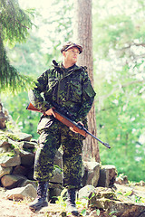 Image showing young soldier or hunter with gun in forest