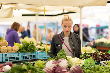 Image showing Woman buying vegetable at local food market. 