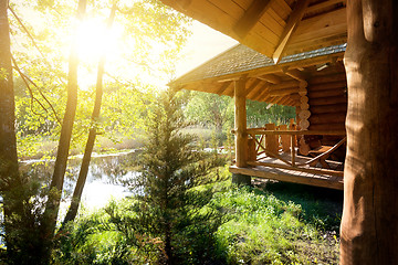 Image showing Wooden house and pond