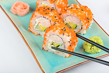 Image showing Sushi roll with black chopsticks 