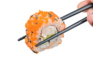 Image showing Sushi roll with black chopsticks 