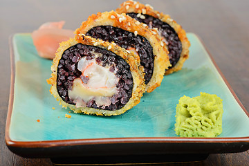 Image showing Baked sushi rolls served on blue plate