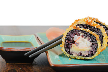 Image showing Baked sushi rolls served on turquoise plate