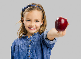 Image showing Cute girl holding an apple