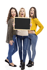 Image showing Teenage girls holding a chalkboard