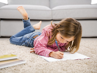 Image showing Little girl making homework