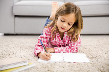 Image showing Little girl making homework