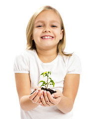 Image showing Cute girl showing a plant