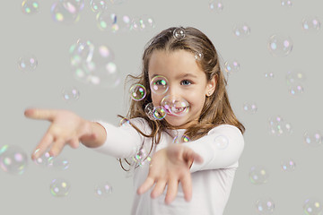 Image showing Girl playing with soap bubbles