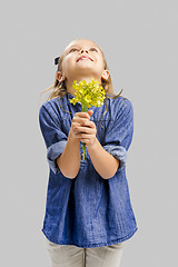 Image showing Cute litle girl holdign flowers