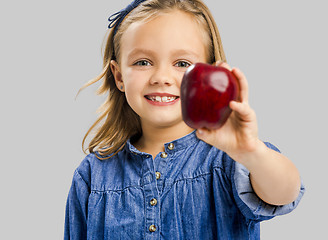 Image showing Cute girl holding an apple