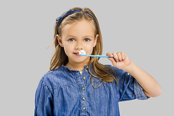 Image showing Little girl brushing teeth