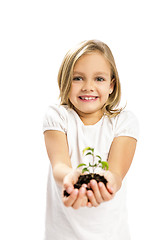 Image showing Cute girl showing a plant