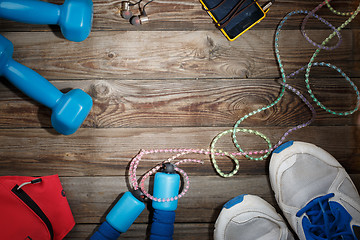 Image showing Sport stuff on wooden table, top view