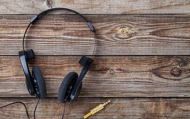 Image showing Headphones over wooden table.