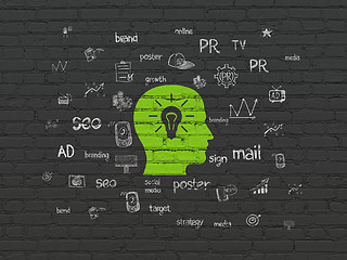 Image showing Advertising concept: Head With Light Bulb on wall background